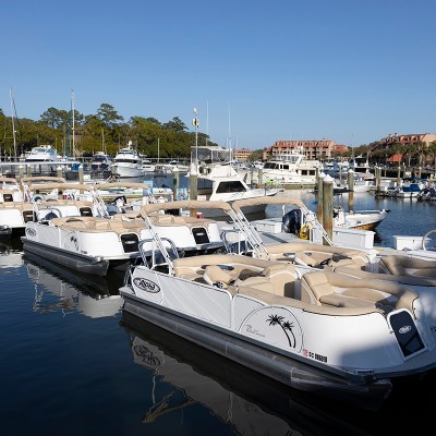 a small boat in a harbor next to a body of water
