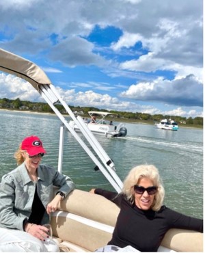 a group of people sitting in a boat on a body of water