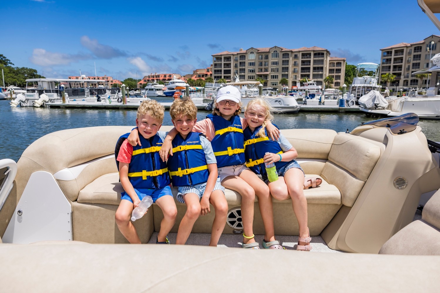 a group of people sitting next to a body of water