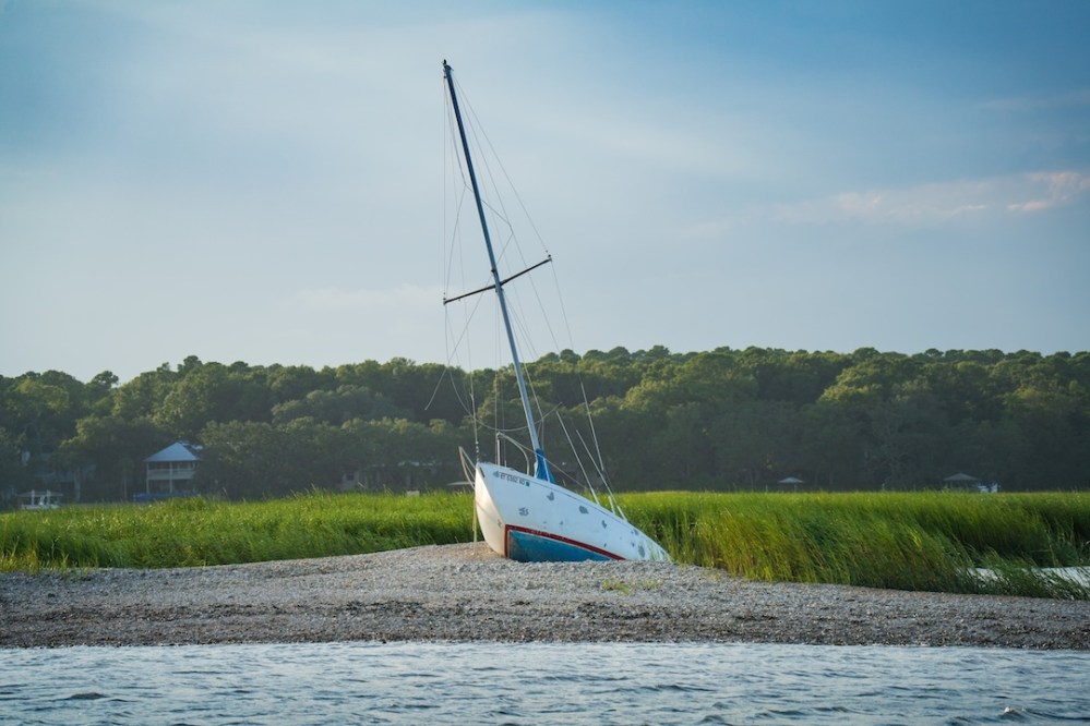 a beached sail in the marsh